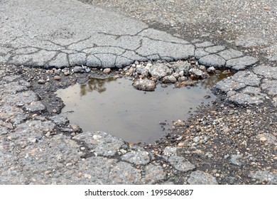 Big Pot Hole Filled With Rain Water Damaged Street Problem