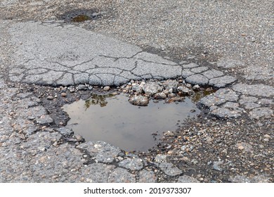 Big Pot Hole Filled With Rain Water Damaged Street Problem