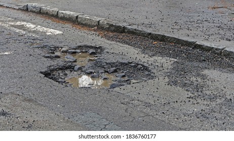 Big Pot Hole Filled With Water At Street