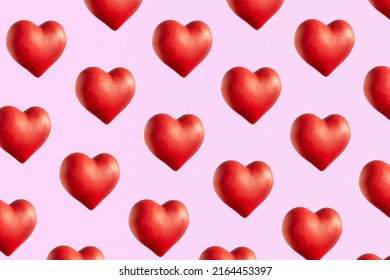 Big red 3d hearts, cute pattern against pastel pink background. Love concept, wallpaper. 