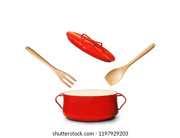 Big red pot for soup with fork and spoon