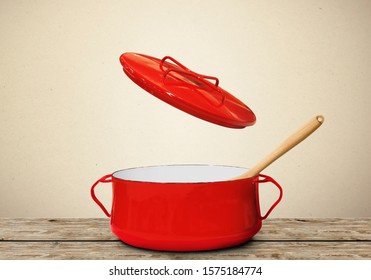 Big Red Pot For Soup With Fork And Spoon