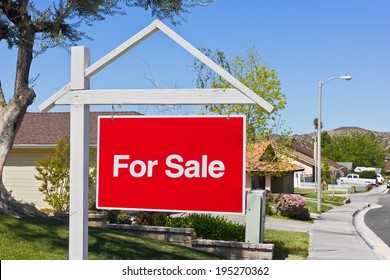 A Big Red Sale Sign Hangs In The Front Yard Of A House In A Suburban Community. 