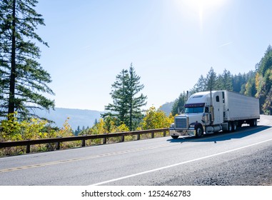 Big Rig American Powerful White Classic Semi Truck Transporting Cargo In Refrigerated Semi Trailer On Winding Autumn Road In Columbia River Gorge In Washington