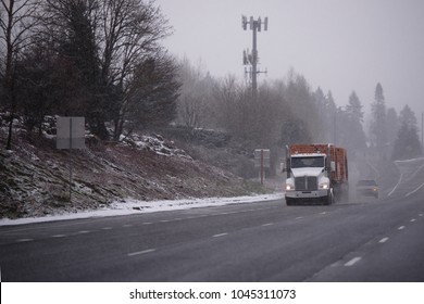 Big Rig Bonnet American White Day Cab Semi Truck Transporting Lumber On Flat Bed Semi Trailer And Driving On Winter Highway In Snow Storm Weather