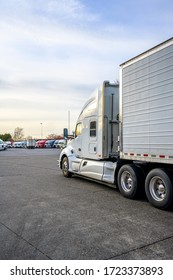 Big Rig Classic Bonnet Industrial Diesel Semi Truck With Refrigerator Semi Trailer Running On The Truck Stop Parking Lot Past Other Parked Trucks Looking For Empty Reserved Parking Spot