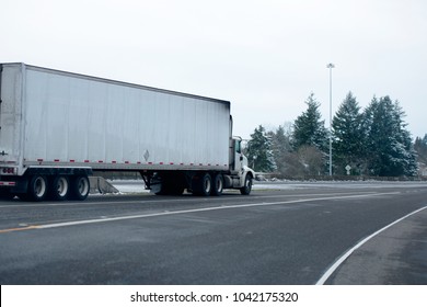 Big Rig Day Cab Semi Truck For Local Deliveries Commercial Cargo In Dry Van Semi Trailer Running In Winter Snowy Storm Weather On The Interstate Multiline Road