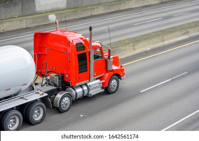 Big Rig Powerful Diesel Industrial Red Semi Truck Transporting Tank Semi Trailer For Carry Liquefied Gas And Other Gaseous Chemicals Cargo Running On The Wide Highway Road
