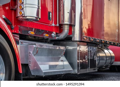 Big Rig Red Heavy-duty Powerful Red Semi Truck With Lot Of Chrome Accessories And Aluminum Footboard Standing On The Truck Stop Parking Lot In Dedicated Spot