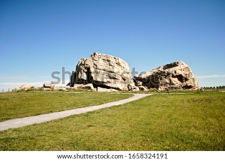 Big Rock Erratic. This massive and unusual rock formation near Okotoks, Alberta, Canada is the world's largest glacial erratic. Large chunks of rock left by ice age glaciers on otherwise flat ground. 