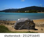 A big rock on a beach in Airlie beach, Australia.