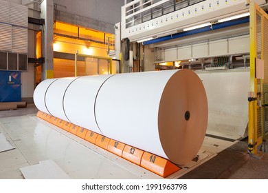 Big Rolls Of Paper Coming Out Of The Machinery In A Paper Mill Plant.