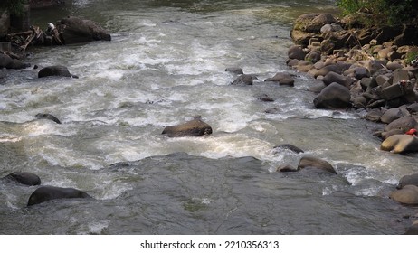 A Big Rushing River With Rocks Around It