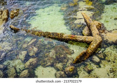 big rusty anchor abandoned in the sea