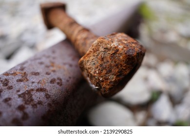 Big rusty bolt screw on railway track