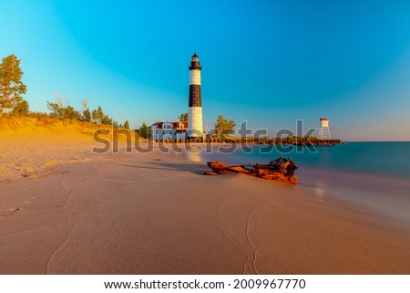 Big Sable Lighthouse in Ludington, Michigan  basks in the sun during golden hour.
