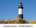 Big sable Point lighthouse at sunset in Ludington State Park along Lake Michigan, Michigan USA. Scenic nature landscape with beach and sand dunes. A peaceful tranquil coastal landscape.