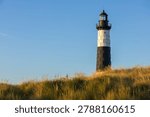 Big sable Point lighthouse at sunset in Ludington State Park along Lake Michigan, Michigan USA. Scenic nature landscape with beach and sand dunes. A peaceful tranquil coastal landscape.