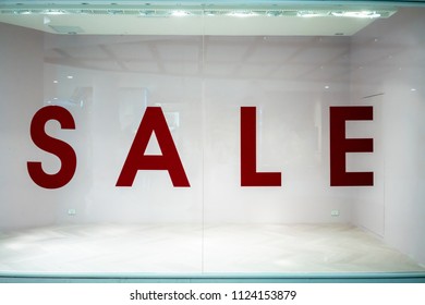 Big Sale Sign On Empty Shop Window In Department Store.