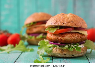 Big Sandwich - Hamburger With Juicy Chicken Burger, Cheese, Tomato,  And Red Onion On Wooden Background