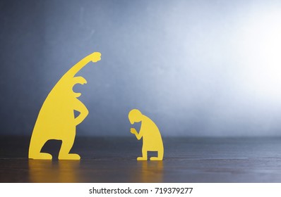 Big screaming man against small miserable man made from yellow paper