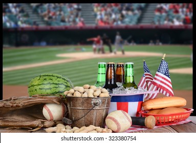 A Big Screen TV With A Baseball Game. In Front Of The Television Is A Spread Of Snack Food, Beer And Sports Equipment. Great For Playoff Or World Series Themed Projects. TV Is Out Of Focus.