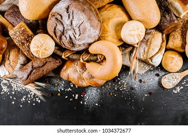 Big Set Of Different Baked Goods On The Black Wooden Background. Top View. Free Space