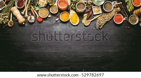 Big set of Indian spices and herbs . On the black chalkboard.