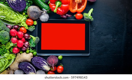 Big set organic food. Fresh raw vegetables. Laptop. On a black chalkboard. - Powered by Shutterstock