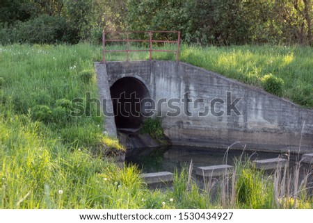 Big sewage drain pipe or effluent release wastewater into the river