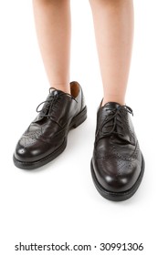 Big Shoes And Child Feet With White Background