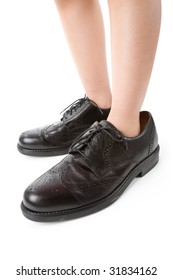 Big Shoes And Child Feet With White Background