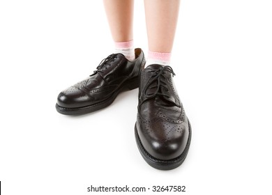 Big Shoes And Child Feet With White Background