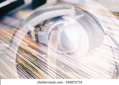 Big Silver DJ Headphones On Vinyl Records Collection.Audio Enthusiast,music Lover Or Professional Disc Jockey Equipment.Hifi Audio Vinyl Record Collector Background.Double Exposure