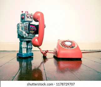 Big Silver Robot Toy On The Phone Standing On An Old Wooden Floor Toned Image 