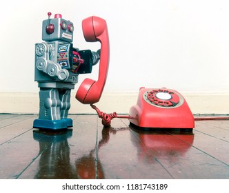 Big Silver Robot Toy On The Phone Standing On An Old Wooden Floor Toned Image