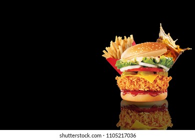Big single cheeseburger with glass of cola and french fries on black background - Powered by Shutterstock