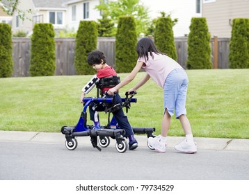 Big Sister Helping Younger Disabled Brother Stock Photo 79734529 ...