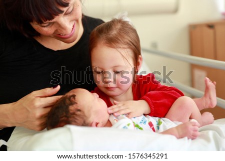 Similar – Relaxed mother and sons playing over the bed