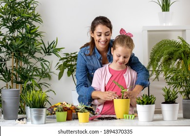 Big Sister Showing Her Little One What Is Plant Potting, Sisters Bonding Concept