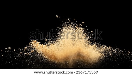 Big size Sand flying explosion, Golden grain wave explode. Abstract cloud fly. Yellow colored sand splash throwing in Air. Black background Isolated series two of imagesblur