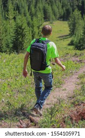 Big Sky Montana July 20 2018 Young Man Walking Down Mountain With GoPro Seeker Backpack On In Summer Sun