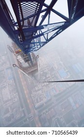 Big skyscraper under construction, top view from top of crane - Shutterstock ID 710565439