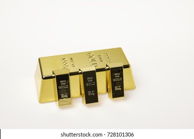 Big And Small Gold Bars On White Isolated