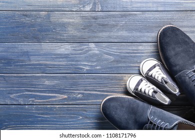 Big And Small Shoes On Wooden Background. Father's Day Celebration