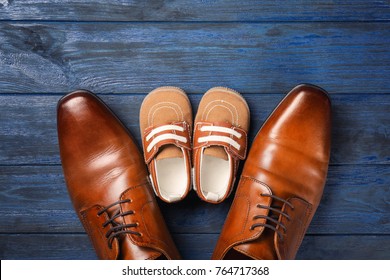 Big And Small Shoes On Wooden Background. Father's Day Composition