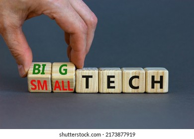 Big Or Small Tech Symbol. Businessman Turns Wooden Cubes And Changes Concept Words Small Tech To Big Tech. Beautiful Grey Table Grey Background, Copy Space. Business And Big Or Small Tech Concept.