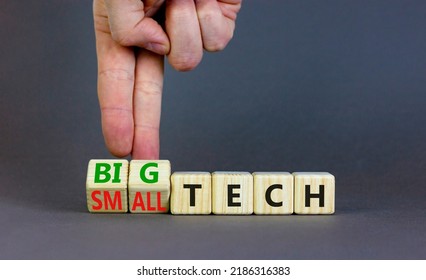 Big Or Small Tech Symbol. Businessman Turns Wooden Cubes And Changes Concept Words Small Tech To Big Tech. Beautiful Grey Table Grey Background, Copy Space. Business And Big Or Small Tech Concept.