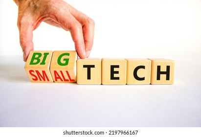 Big Or Small Tech Symbol. Businessman Turns Wooden Cubes And Changes Concept Words Small Tech To Big Tech. Beautiful White Table White Background, Copy Space. Business And Big Or Small Tech Concept.