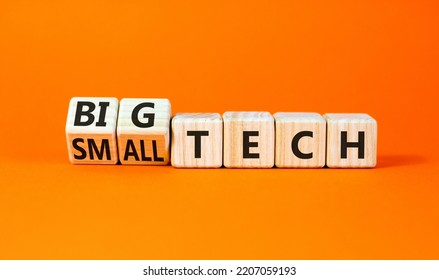 Big Or Small Tech Symbol. Turned Wooden Cubes And Changed Concept Words Small Tech To Big Tech. Beautiful Orange Table Orange Background, Copy Space. Business And Big Or Small Tech Concept.